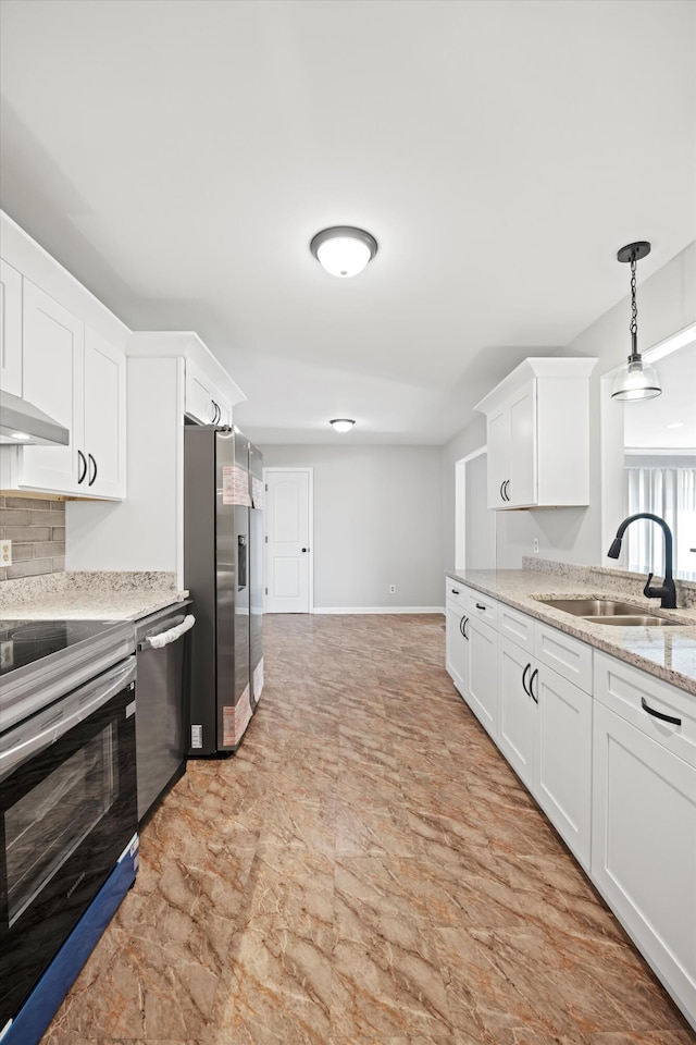 76 Roswell Rd, Rossville, GA 30741 - kitchen featuring appliances with stainless steel finishes, white cabinetry, light stone countertops, hanging light fixtures, and backsplash