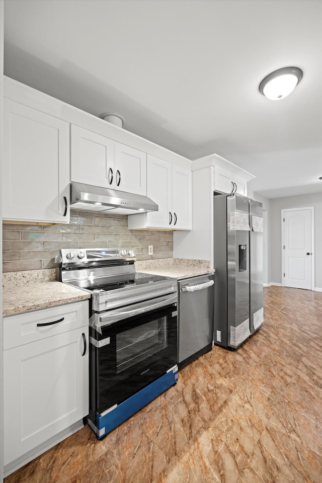 76 Roswell Rd, Rossville, GA 30741 - kitchen featuring stainless steel appliances, under cabinet range hood, white cabinets, backsplash, and light stone countertops