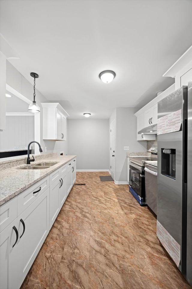 76 Roswell Rd, Rossville, GA 30741 - kitchen featuring appliances with stainless steel finishes, white cabinets, decorative light fixtures, and under cabinet range hood