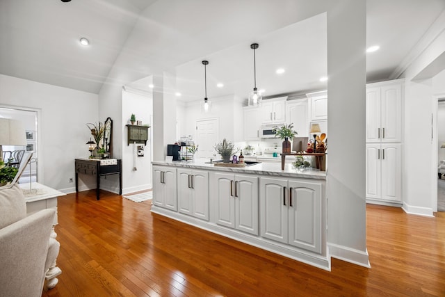 51 Montview Ct, Ringgold, GA 30736 - kitchen featuring white microwave, white cabinets, light wood-style flooring, pendant lighting, and light stone counters