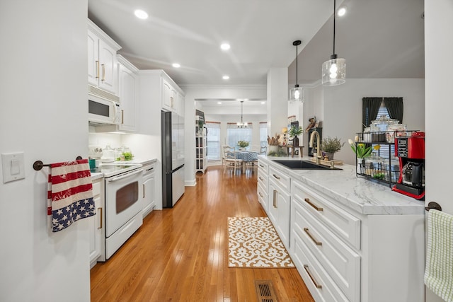 51 Montview Ct, Ringgold, GA 30736 - kitchen featuring white appliances, white cabinets, light wood-type flooring, pendant lighting, and recessed lighting