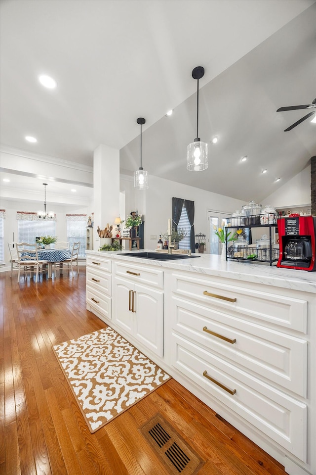 51 Montview Ct, Ringgold, GA 30736 - kitchen with hardwood / wood-style floors, lofted ceiling, white cabinetry, ceiling fan, and decorative light fixtures