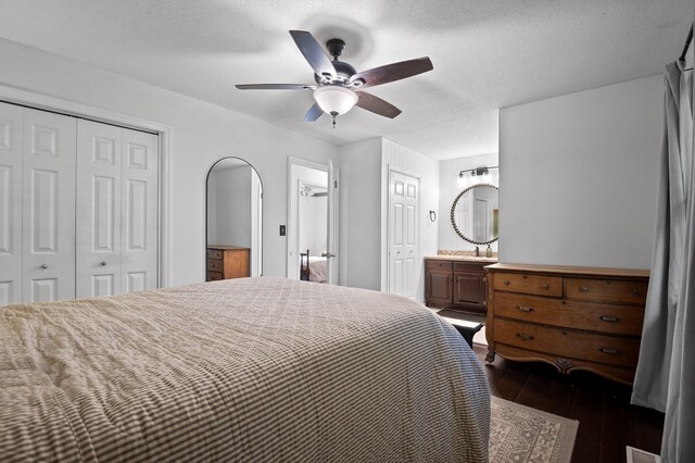 1303 Rockdale Ln, Hixson, TN 37343 - bedroom with dark wood-style floors, arched walkways, ensuite bath, a ceiling fan, and a closet