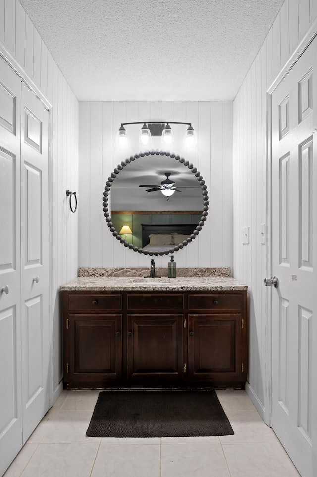 1303 Rockdale Ln, Hixson, TN 37343 - bathroom featuring a textured ceiling, vanity, a ceiling fan, and tile patterned floors