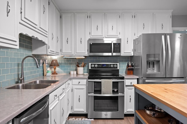 1303 Rockdale Ln, Hixson, TN 37343 - kitchen featuring appliances with stainless steel finishes, white cabinets, backsplash, and wood finished floors