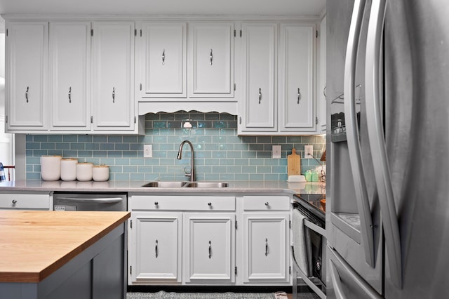 1303 Rockdale Ln, Hixson, TN 37343 - kitchen with stainless steel appliances, wood counters, white cabinetry, and tasteful backsplash