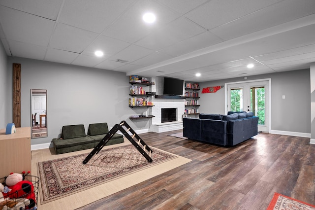 1303 Rockdale Ln, Hixson, TN 37343 - living room with french doors, wood finished floors, a brick fireplace, recessed lighting, and a drop ceiling