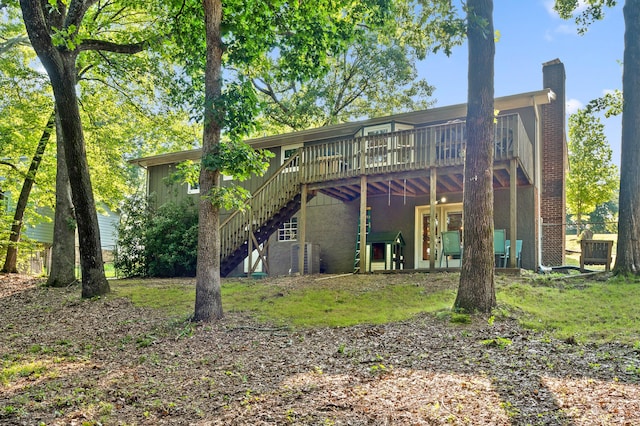 1303 Rockdale Ln, Hixson, TN 37343 - back of property with a wooden deck, stairway, and a chimney