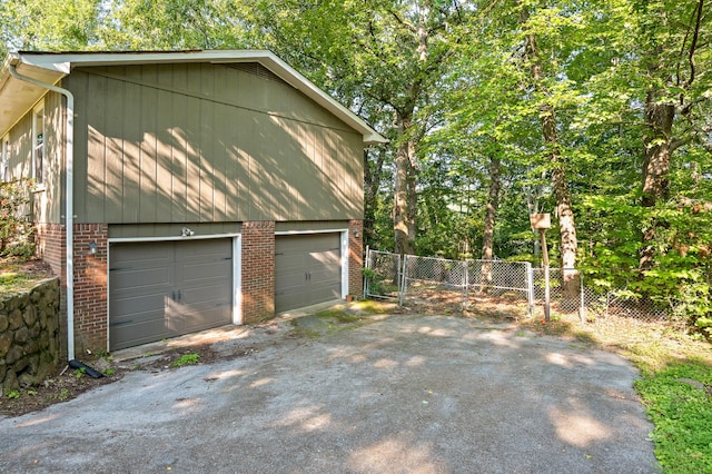 1303 Rockdale Ln, Hixson, TN 37343 - view of side of property with brick siding, a garage, and asphalt driveway