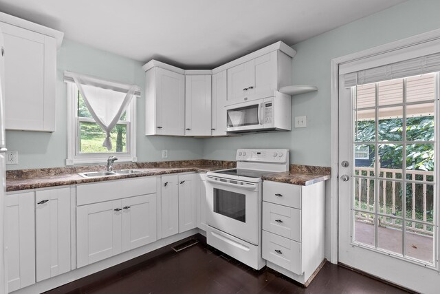 702 Runyan Dr, Chattanooga, TN 37405 - kitchen with white appliances, white cabinetry, dark countertops, and dark wood-style floors