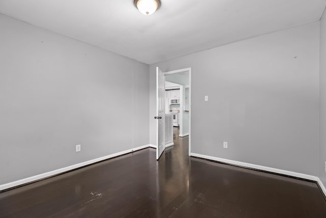 702 Runyan Dr, Chattanooga, TN 37405 - spare room featuring dark wood-type flooring and baseboards
