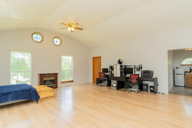 515 Choctaw Trl, Chattanooga, TN 37405 - bedroom with freestanding refrigerator, wood finished floors, an office area, vaulted ceiling, and a glass covered fireplace