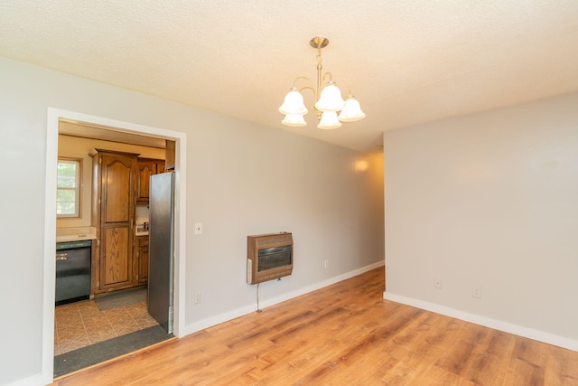 515 Choctaw Trl, Chattanooga, TN 37405 - empty room featuring heating unit, a chandelier, and light wood-style flooring