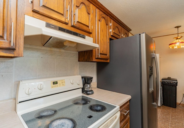 515 Choctaw Trl, Chattanooga, TN 37405 - kitchen with white range with electric cooktop, under cabinet range hood, brown cabinets, tasteful backsplash, and a textured ceiling