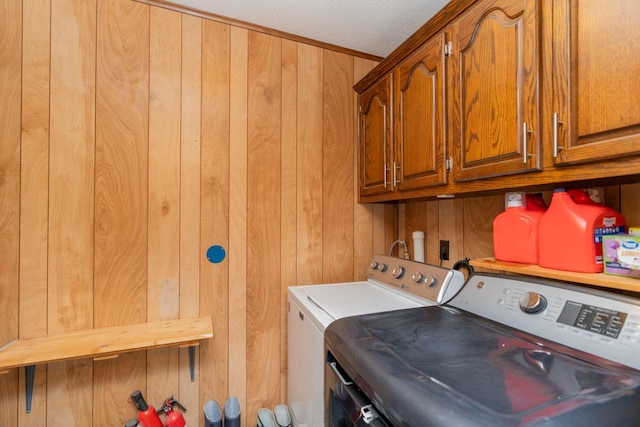 515 Choctaw Trl, Chattanooga, TN 37405 - laundry area with washing machine and clothes dryer, cabinet space, and wood walls