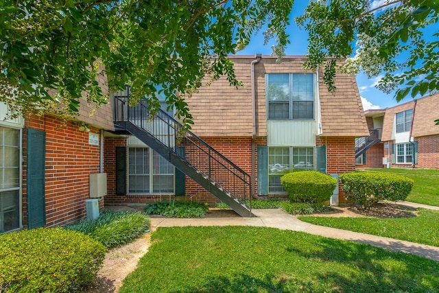 900 Mountain Creek Rd Unit P224, Chattanooga, TN 37405 - view of front of house with brick siding, a front lawn, stairway, and mansard roof
