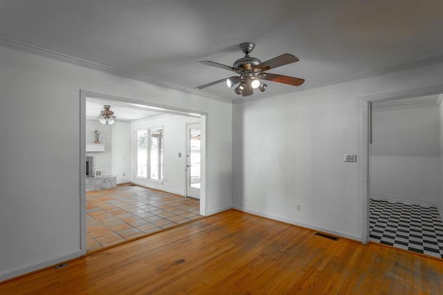 210 Dawn St, Signal Mountain, TN 37377 - unfurnished room with ceiling fan, wood finished floors, ornamental molding, and a brick fireplace