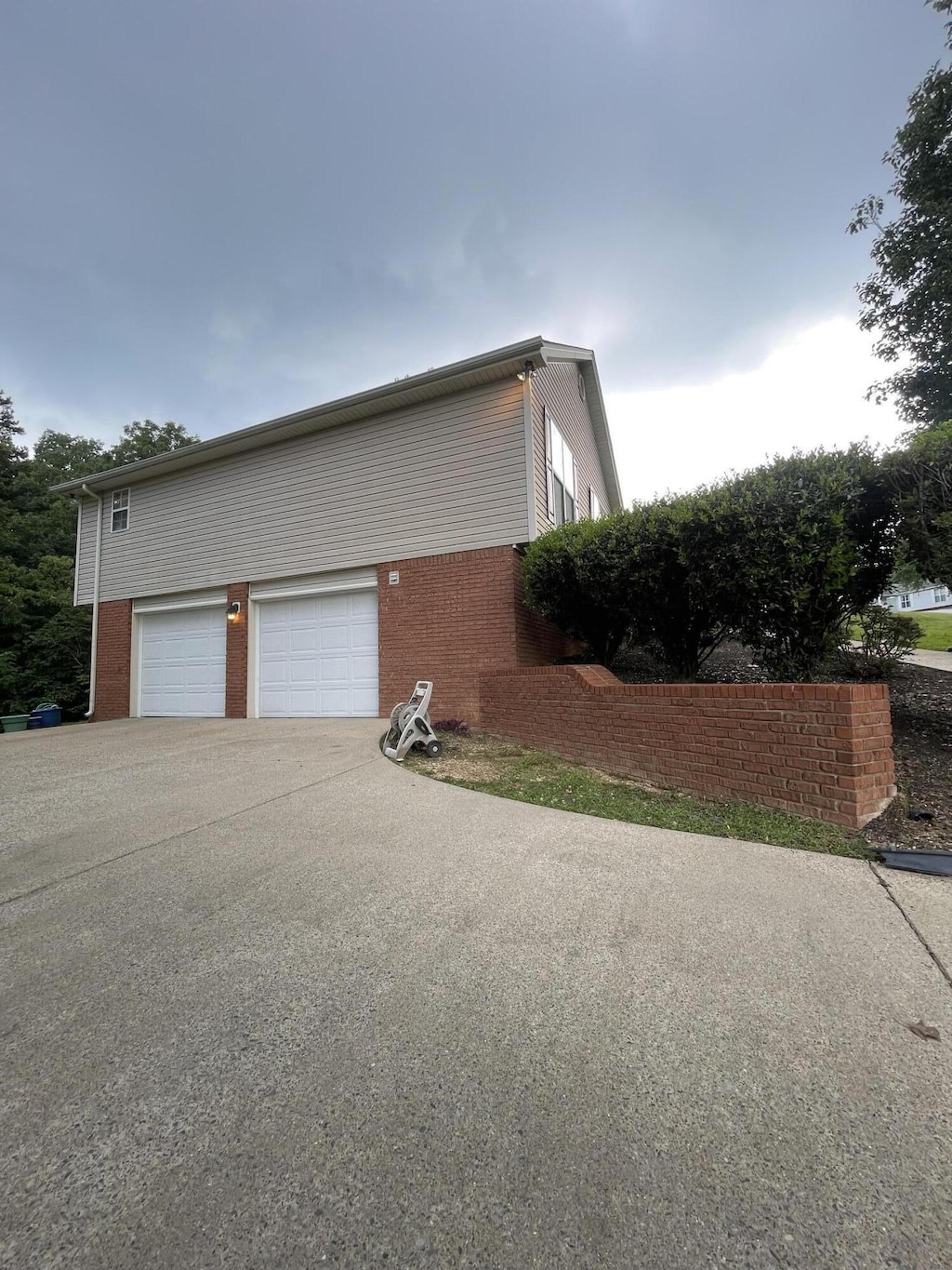 10164 Fielding Rd, Ooltewah, TN 37363 - view of home's exterior featuring brick siding, driveway, and an attached garage