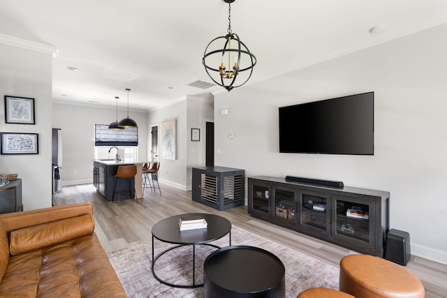 1476 Chatt City Way, Chattanooga, TN 37408 - living room with light wood-type flooring, a chandelier, and crown molding