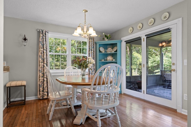6233 Brenda Ct, Harrison, TN 37341 - dining room with a chandelier, wood-type flooring, and a textured ceiling