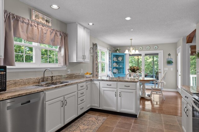 6233 Brenda Ct, Harrison, TN 37341 - kitchen featuring dishwasher, a chandelier, a peninsula, white cabinets, and a textured ceiling