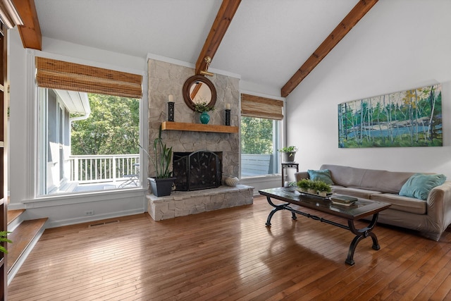6233 Brenda Ct, Harrison, TN 37341 - living room featuring beamed ceiling, hardwood / wood-style flooring, a stone fireplace, and high vaulted ceiling