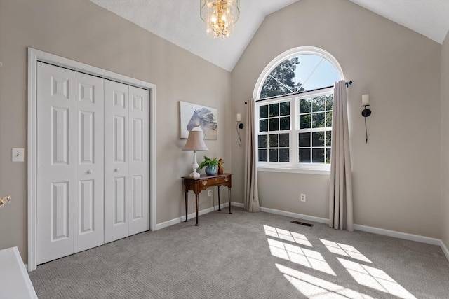 6233 Brenda Ct, Harrison, TN 37341 - foyer entrance featuring carpet flooring, vaulted ceiling, and a chandelier