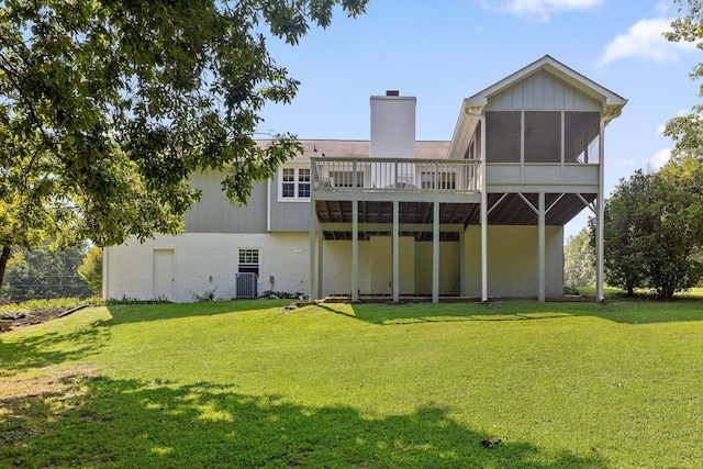 6233 Brenda Ct, Harrison, TN 37341 - rear view of house with a sunroom, a chimney, a yard, and a wooden deck