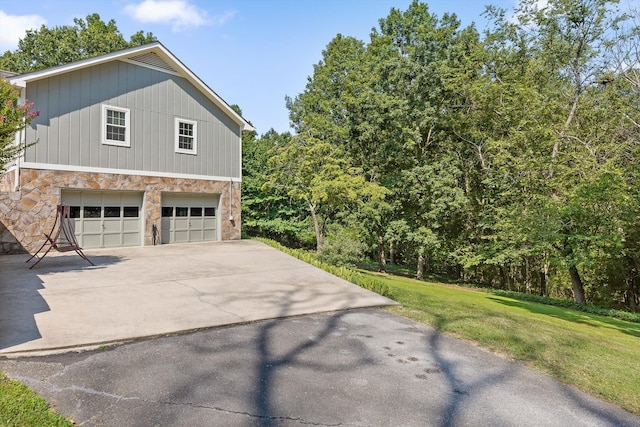 6233 Brenda Ct, Harrison, TN 37341 - view of property exterior featuring stone siding, concrete driveway, and a yard