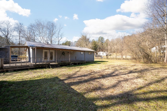 1153 Coffelt Rd, Hixson, TN 37343 - back of property with a wooden deck, a yard, a metal roof, and french doors