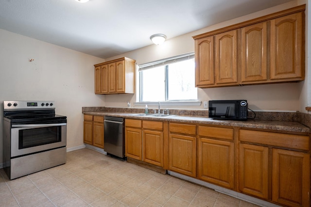 1153 Coffelt Rd, Hixson, TN 37343 - kitchen with appliances with stainless steel finishes, dark countertops, and brown cabinets