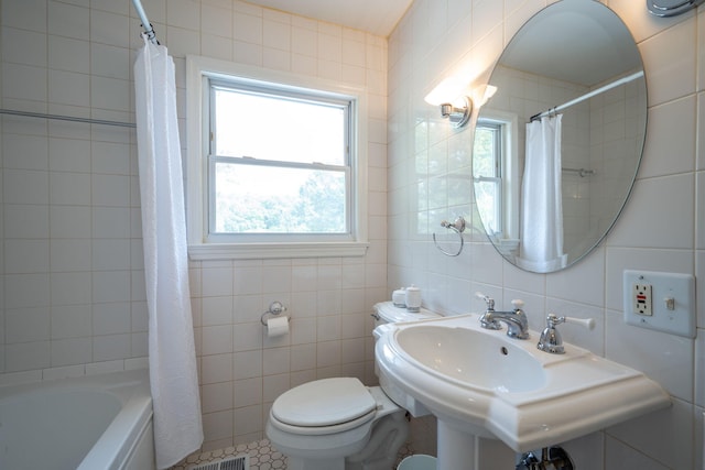 3707 Norma Dr, Chattanooga, TN 37412 - full bathroom with tile walls, plenty of natural light, and shower / bath combo with shower curtain