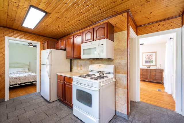 3707 Norma Dr, Chattanooga, TN 37412 - kitchen with white appliances, wood walls, light countertops, wooden ceiling, and a ceiling fan
