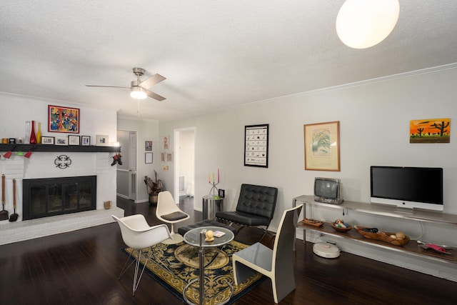 100 Pine Cone Ln, Chattanooga, TN 37415 - living area with wood finished floors, a ceiling fan, ornamental molding, a fireplace, and a textured ceiling