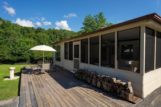 100 Pine Cone Ln, Chattanooga, TN 37415 - wooden terrace with a sunroom, outdoor dining area, a yard, and a wooded view