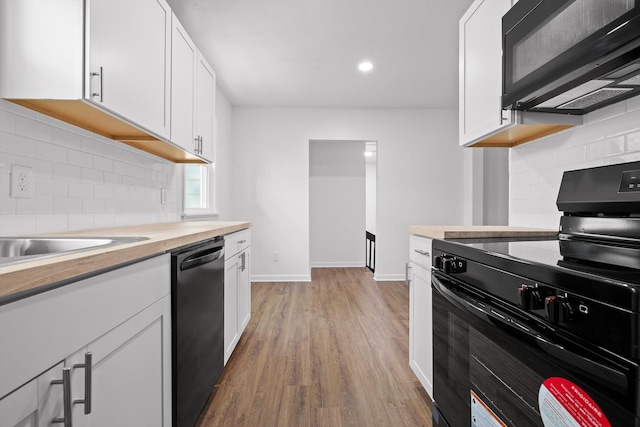 3002 Peggy Ln, Chattanooga, TN 37404 - kitchen featuring black appliances, tasteful backsplash, white cabinetry, light wood-type flooring, and recessed lighting