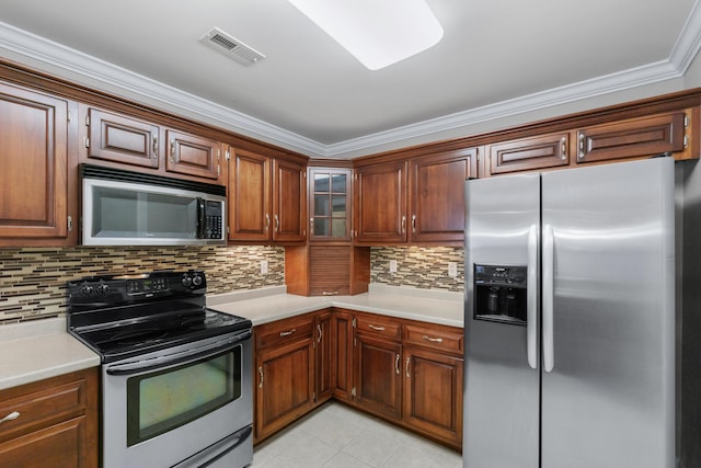 3609 Brass Lantern Way, Chattanooga, TN 37415 - kitchen with stainless steel appliances, light countertops, decorative backsplash, light tile patterned floors, and crown molding