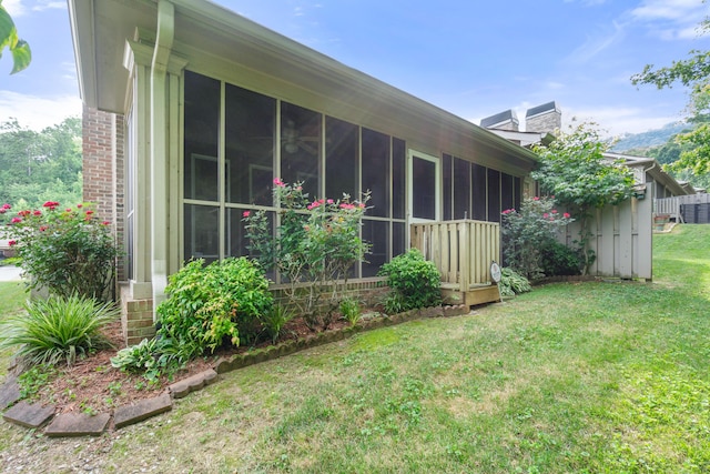 3609 Brass Lantern Way, Chattanooga, TN 37415 - view of side of home featuring a sunroom, a yard, a chimney, and brick siding