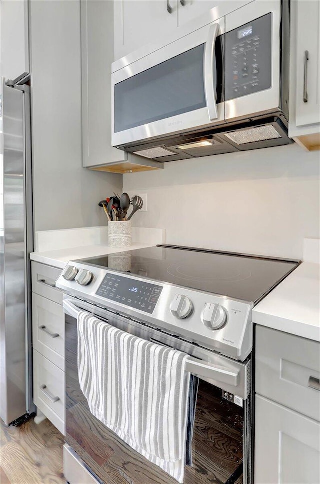 280 W 16th St, Chattanooga, TN 37408 - kitchen with appliances with stainless steel finishes, light countertops, light wood-style floors, and gray cabinets