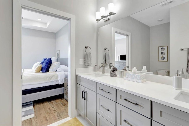 280 W 16th St, Chattanooga, TN 37408 - ensuite bathroom featuring double vanity, wood finished floors, recessed lighting, and a raised ceiling