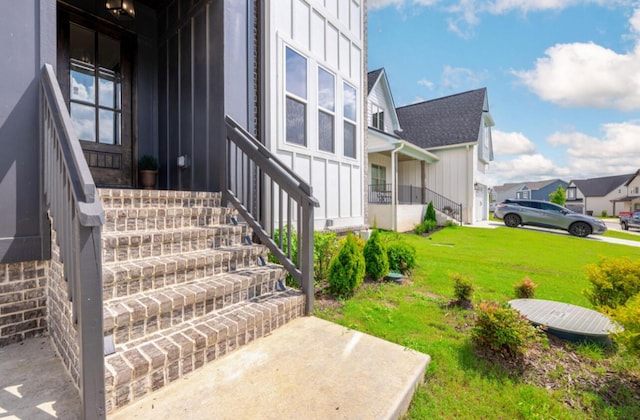 8340 Snowdrop Way, Ooltewah, TN 37363 - property entrance with board and batten siding and a lawn