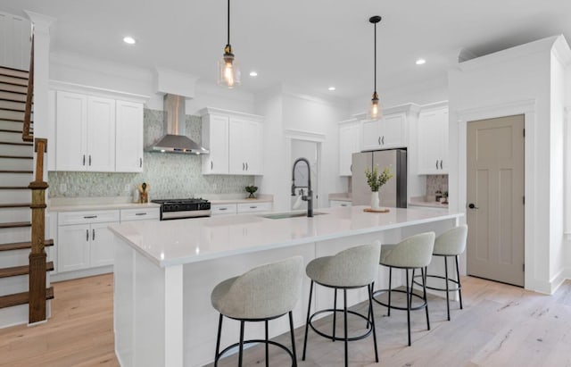 8340 Snowdrop Way, Ooltewah, TN 37363 - kitchen with wall chimney range hood, freestanding refrigerator, black gas range, tasteful backsplash, and white cabinets