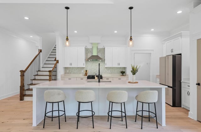 8340 Snowdrop Way, Ooltewah, TN 37363 - kitchen with freestanding refrigerator, wall chimney exhaust hood, light countertops, white cabinetry, and recessed lighting
