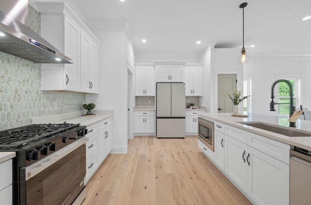 8340 Snowdrop Way, Ooltewah, TN 37363 - kitchen featuring wall chimney range hood, stainless steel appliances, crown molding, backsplash, and light countertops