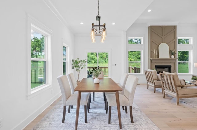8340 Snowdrop Way, Ooltewah, TN 37363 - dining area featuring a chandelier, light wood-style floors, recessed lighting, and a fireplace