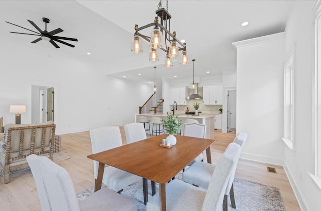 8340 Snowdrop Way, Ooltewah, TN 37363 - dining space with light wood-type flooring, recessed lighting, ceiling fan, and a chandelier