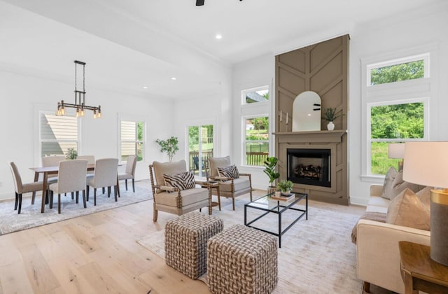 8340 Snowdrop Way, Ooltewah, TN 37363 - living room with light wood-style floors, a large fireplace, ceiling fan, recessed lighting, and a chandelier