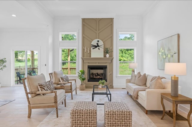 8340 Snowdrop Way, Ooltewah, TN 37363 - living room featuring plenty of natural light, crown molding, light wood finished floors, a large fireplace, and recessed lighting