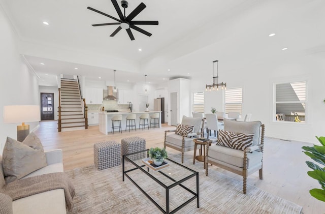 8340 Snowdrop Way, Ooltewah, TN 37363 - living area with a ceiling fan, light wood-style flooring, recessed lighting, stairs, and a chandelier