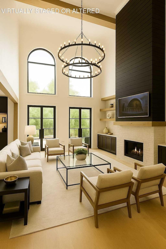 1103 Centennial Dr, Chattanooga, TN 37405 - living area featuring a chandelier, a towering ceiling, wood finished floors, and a large fireplace